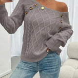 Gray cable-knit long-sleeve sweater with wide neckline and gold button accents