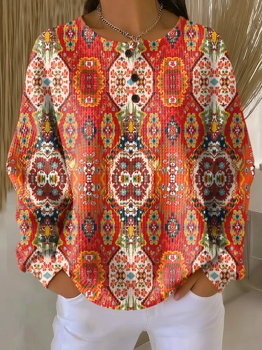 Orange ethnic floral pullover with long sleeves and button-front placket