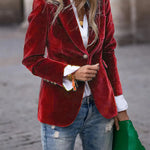 Red velvet blazer with notch lapels, single-breasted front, gold button closure, flap pockets