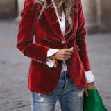Red velvet blazer with notch lapels, single-breasted front, gold button closure, flap pockets