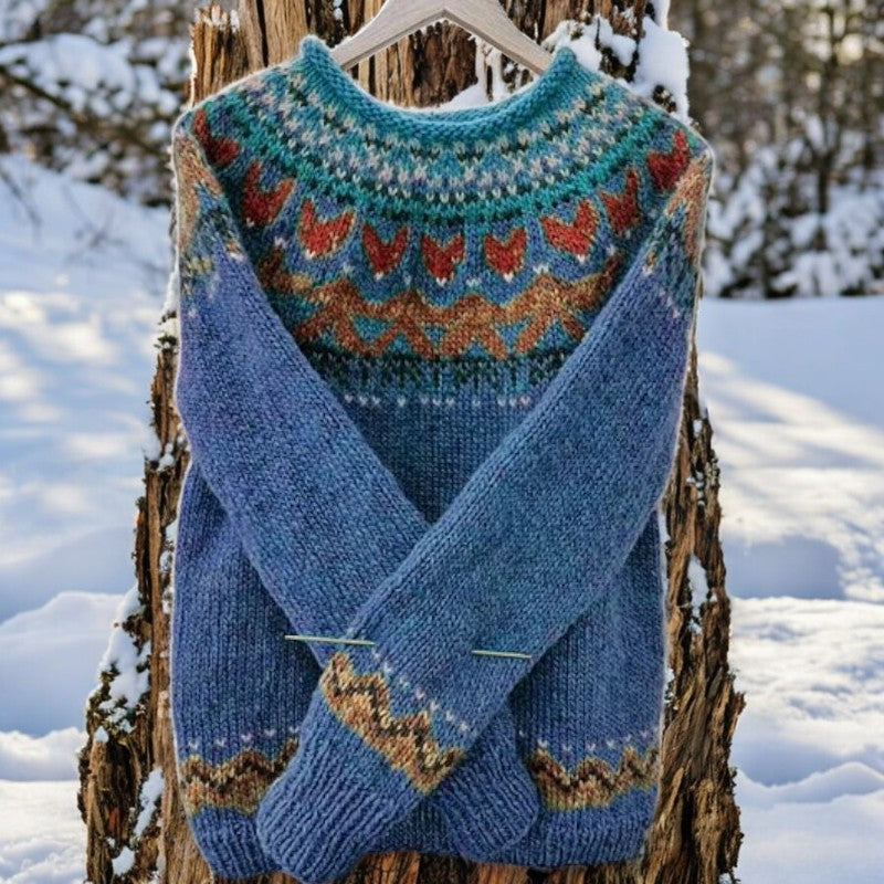 Blue knit pullover with crew neck, long sleeves, and multicolor zigzag yoke