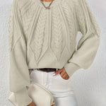 Cream cable-knit long-sleeve pullover with half-zip neckline and ribbed cuffs
