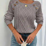 Gray cable-knit long-sleeve sweater with round neckline and gold button accents