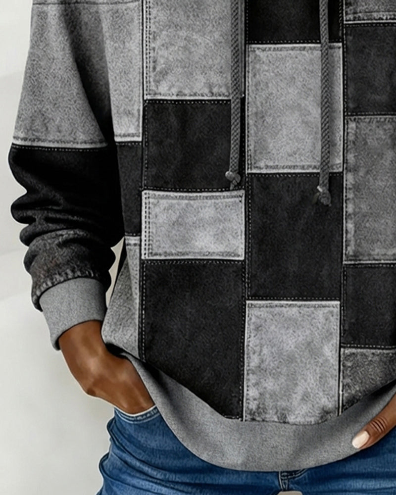 Gray patchwork hoodie close-up with hood strings and stitched square front panels