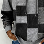 Gray patchwork hoodie close-up with hood strings and stitched square front panels