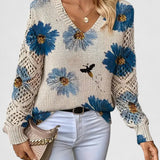 Relaxed floral pullover sweater, cream knit with blue flower print, V-neck, long sleeves