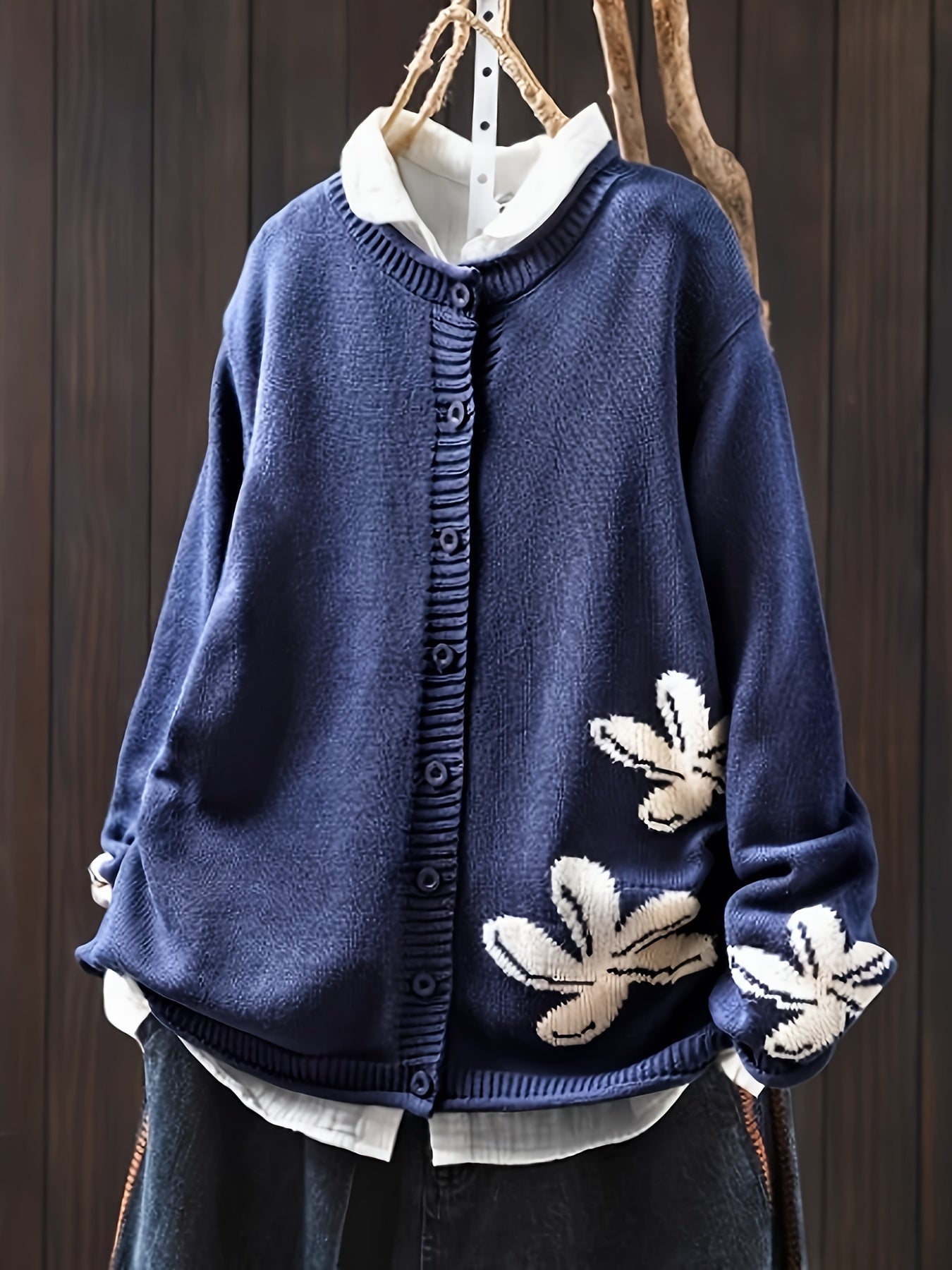 Navy blue floral knit cardigan sweater with button front and ribbed cuffs