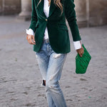 Green velvet blazer with notch lapels and gold buttons, long sleeves, structured fit