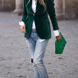 Green velvet blazer with notch lapels and gold buttons, long sleeves, structured fit