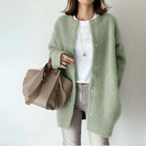 Green open-front cardigan with long sleeves and snap-button placket