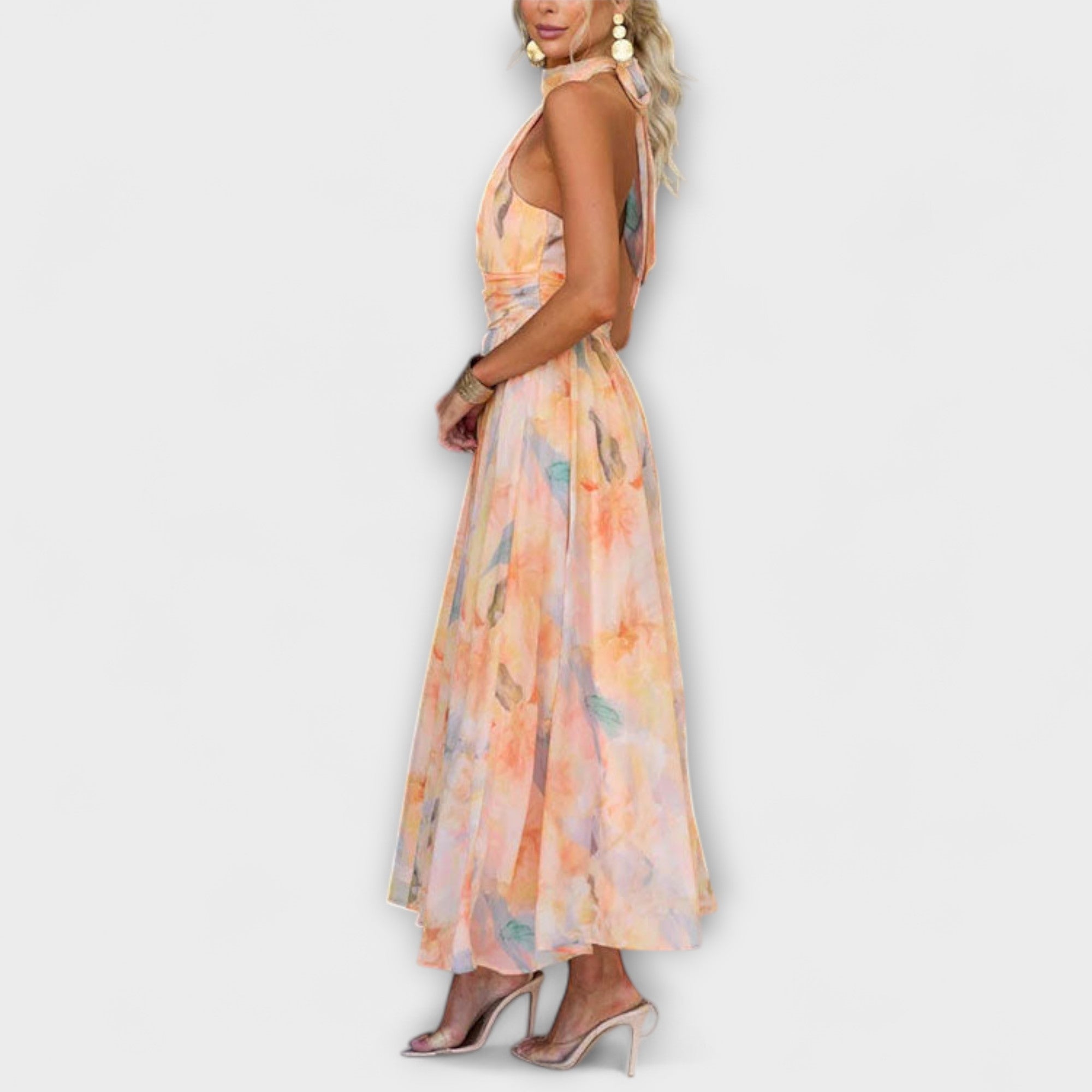 Side view halter maxi dress with flowing skirt and pastel watercolor print