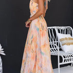 Peach watercolor halter maxi dress with sleeveless cut and flowing A-line skirt