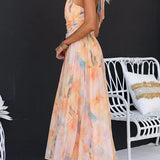 Peach watercolor halter maxi dress with sleeveless cut and flowing A-line skirt