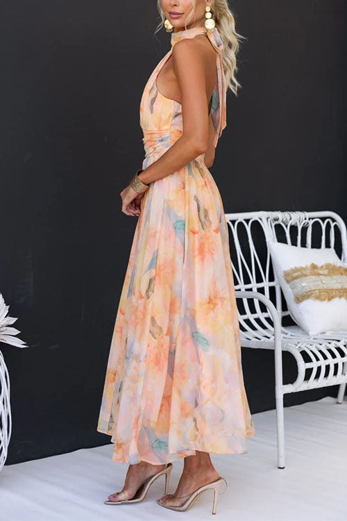 Peach watercolor halter maxi dress with sleeveless cut and flowing A-line skirt