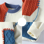 Close-up of color-block knit sweater: orange cable, cream body, blue decorative stitching
