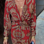 Red patterned V-neck midi dress with knotted front and long sleeves