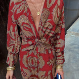 Red patterned V-neck midi dress with knotted front and long sleeves