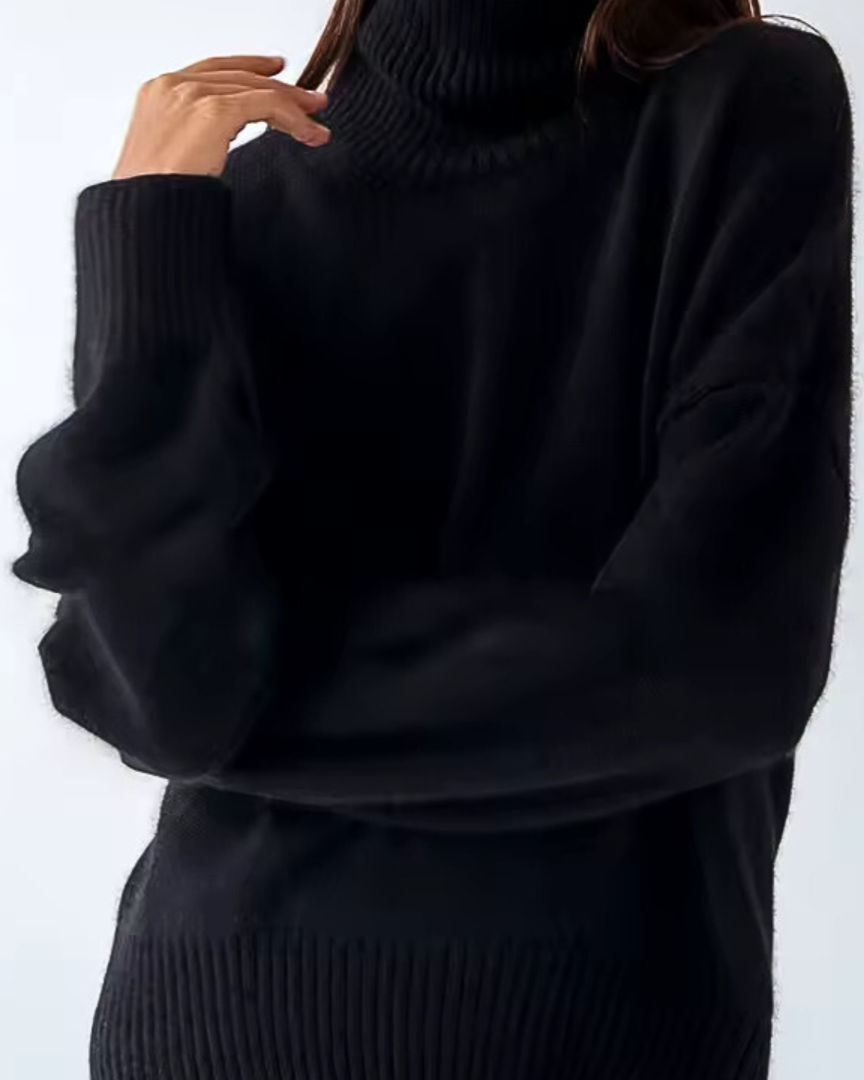 Oversized black turtleneck knit sweater with ribbed collar and hem