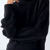 Oversized black turtleneck knit sweater with ribbed collar and hem