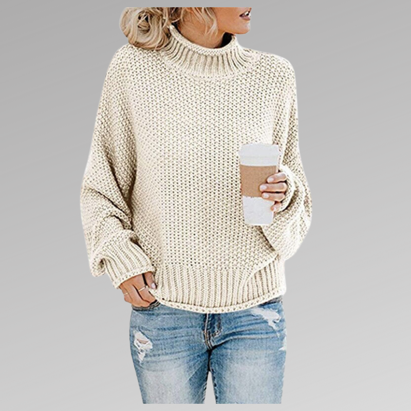Cream chunky knit sweater with ribbed turtleneck, long sleeves, and straight hem