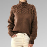 Women's cable-knit turtleneck sweater, brown textured panel and ribbed cuffs.