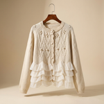 Cream cardigan on hanger with textured bobble pattern and layered ruffle trim
