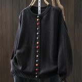 Dark charcoal knit cardigan with round neckline and multicolor button-front placket.