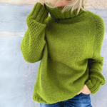 Green oversized rollneck sweater with high collar, long sleeves, ribbed cuffs