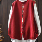 Red sleeveless knit cardigan with vertical button placket and ribbed collar and hem