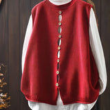 Red sleeveless knit cardigan with vertical button placket and ribbed collar and hem
