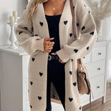 Heart-pattern knit cardigan with open front, long sleeves, light beige knit with dark hearts.