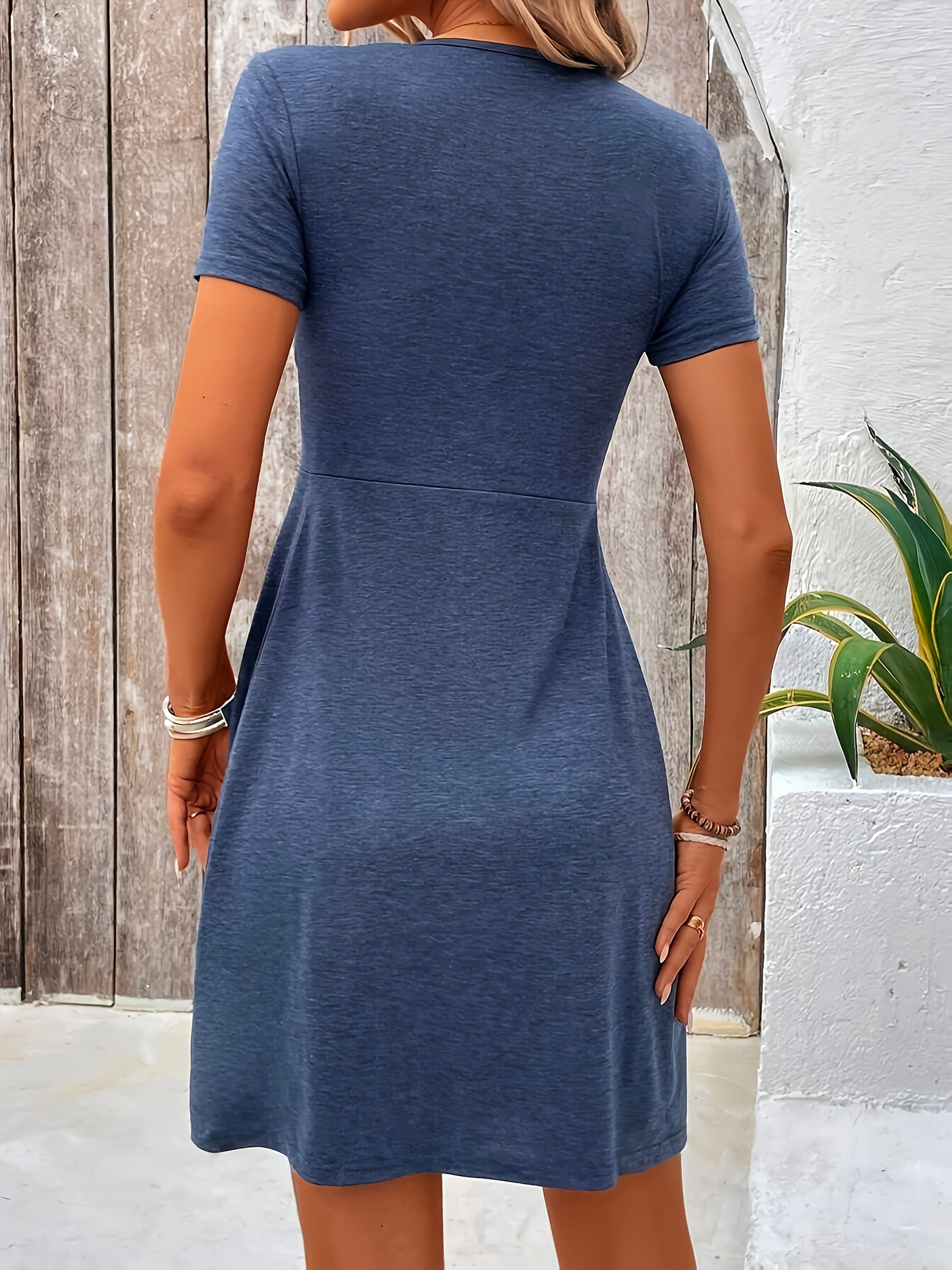 Blue short-sleeve dress, back view, fitted waist with flared skirt