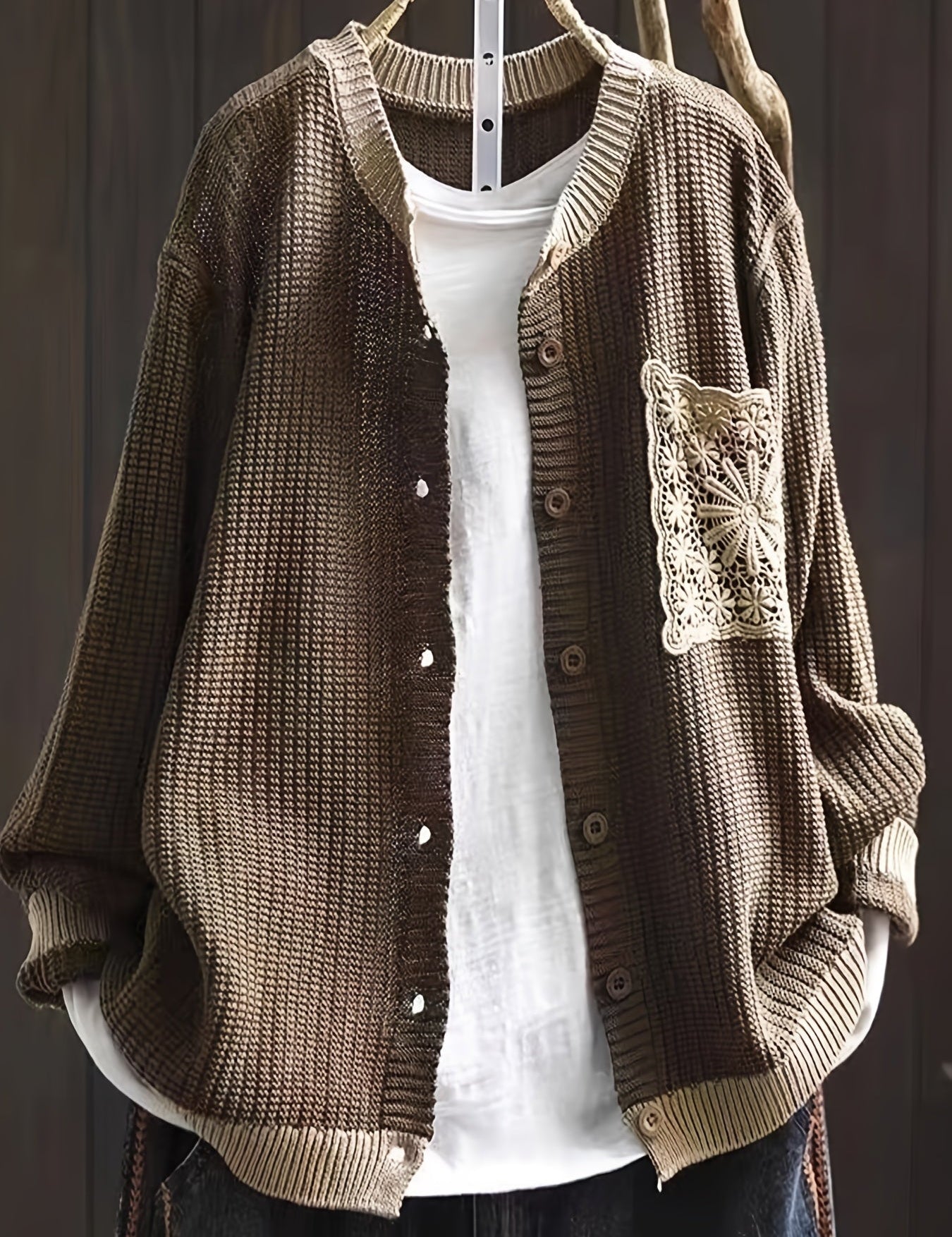 Dark brown knit cardigan, button front, ribbed trim, long sleeves, crocheted chest patch