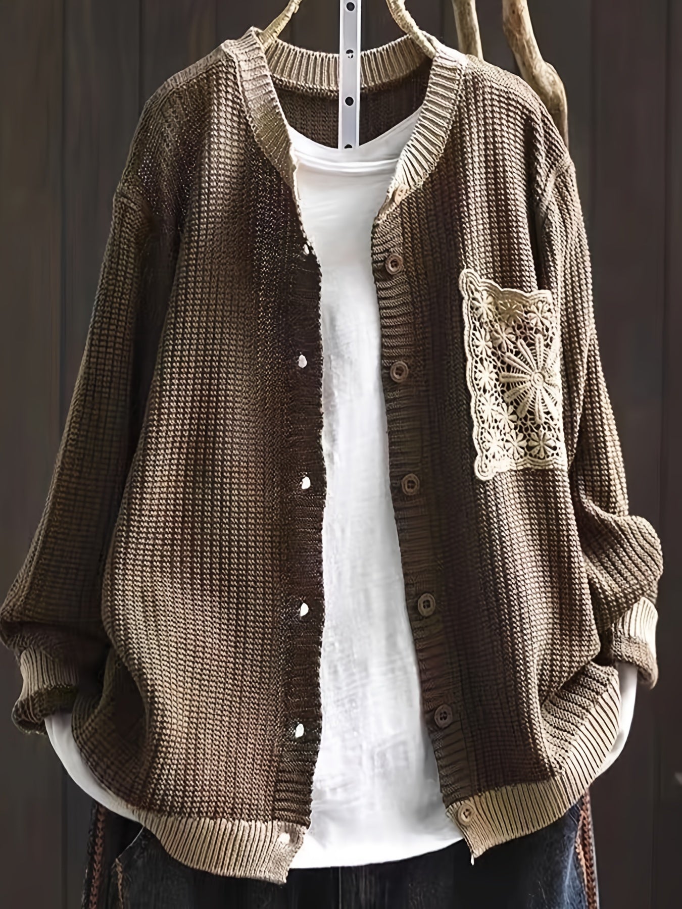 Dark brown knit cardigan, button front, ribbed trim, long sleeves, crocheted chest patch