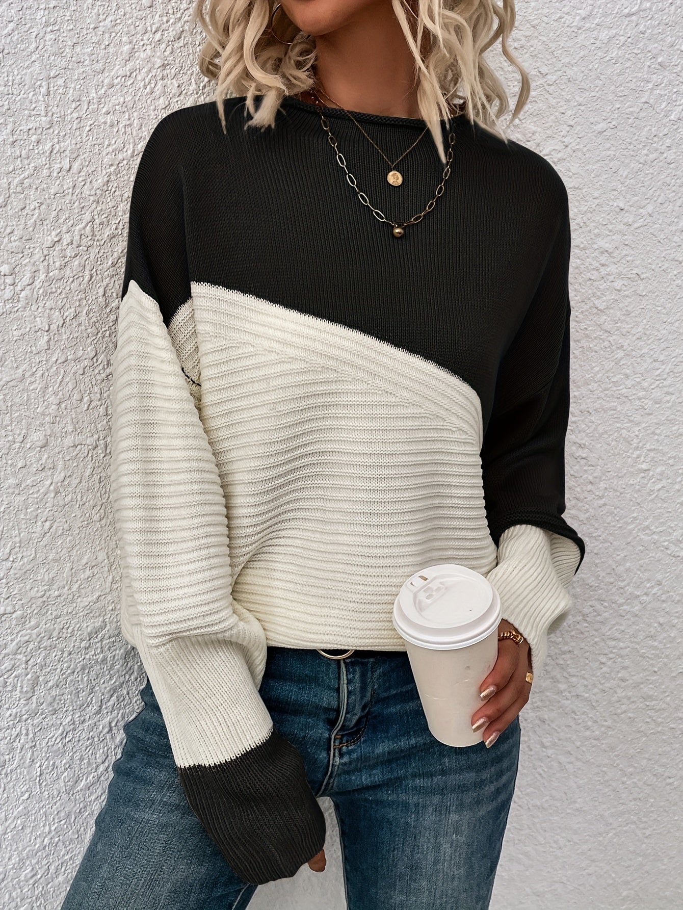 Black and white color-block pullover sweater with long sleeves and crew neck