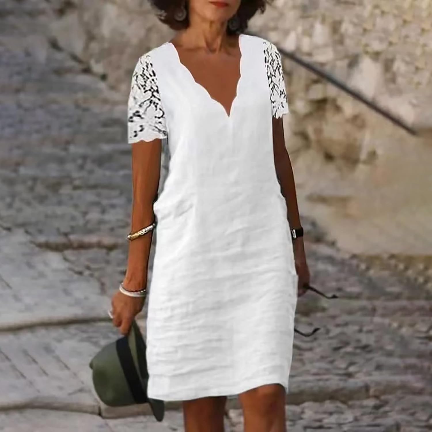 White V-neck knee-length dress with lace short sleeves and fitted shift silhouette.