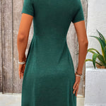 Green short-sleeve dress, back view, fitted waist and flared skirt