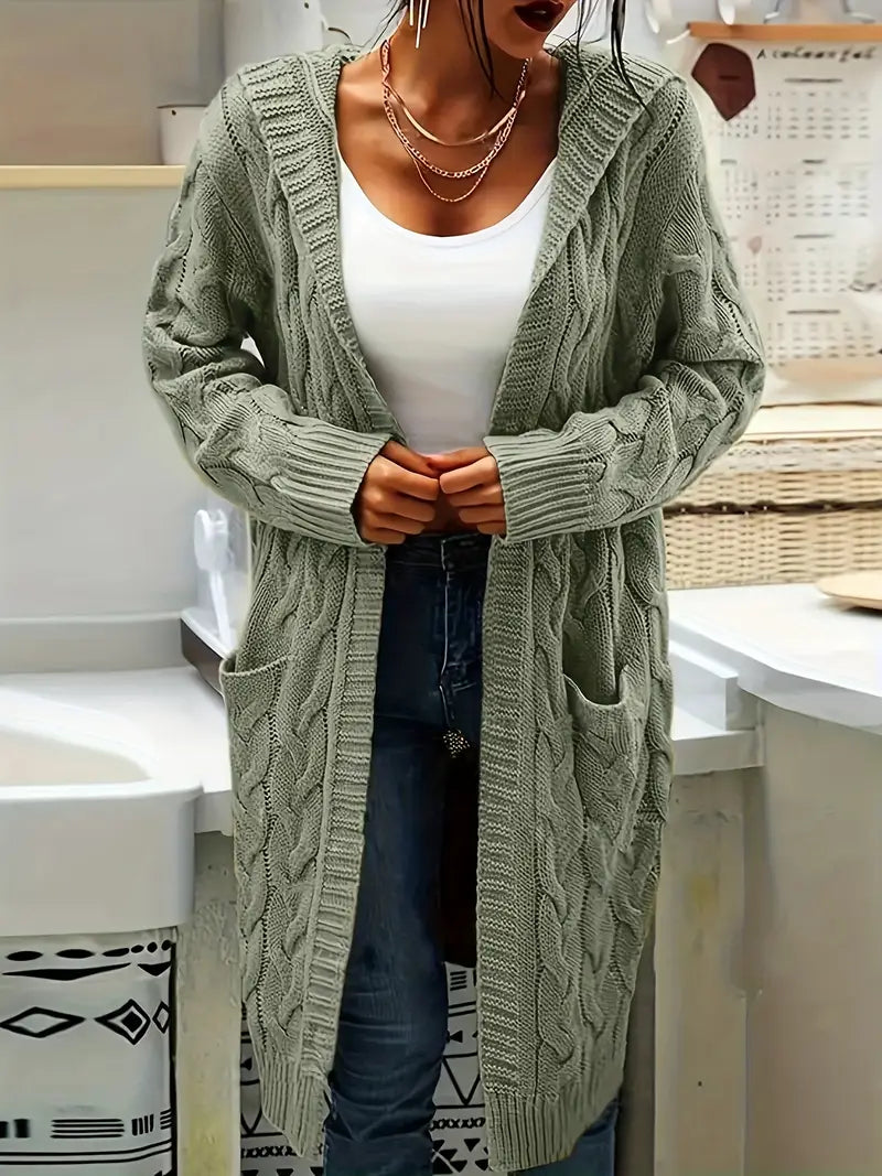 Mint green cable-knit long cardigan, open front, draped over denim