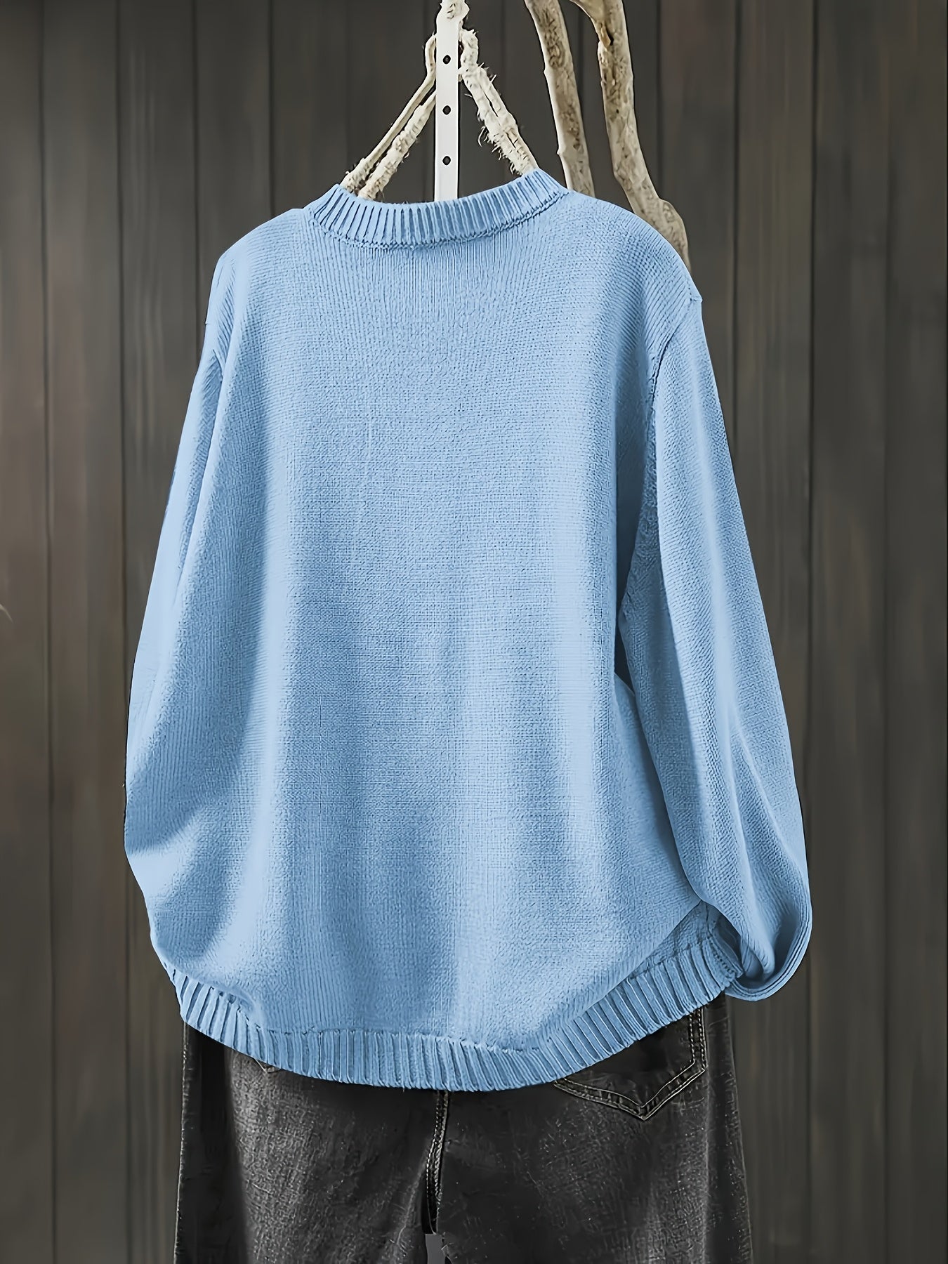 Light blue cardigan sweater with ribbed collar, cuffs, and rounded hem