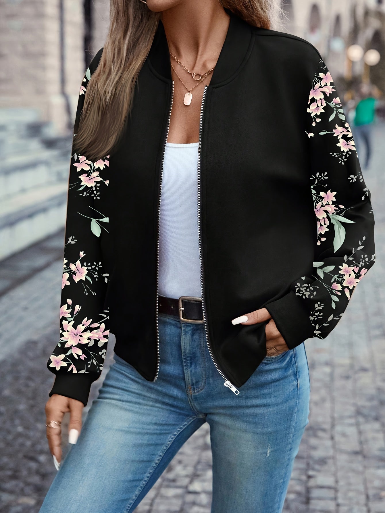 Black zip-front jacket with floral sleeves, stand collar and side pockets