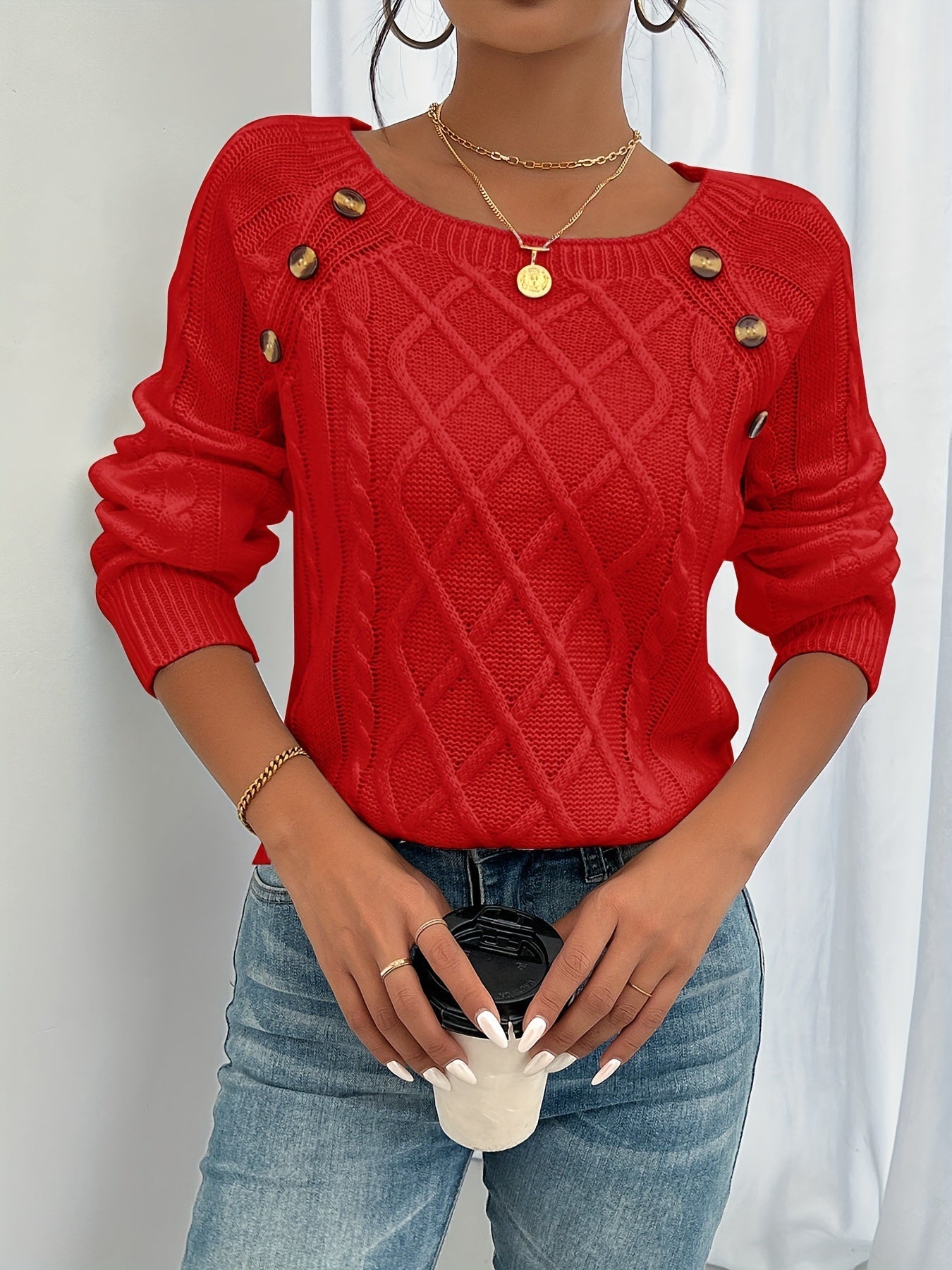 Red cable-knit crewneck sweater with decorative shoulder buttons and ribbed cuffs