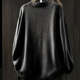 Black cardigan sweater with ribbed crew neckline, cuffs, and hem