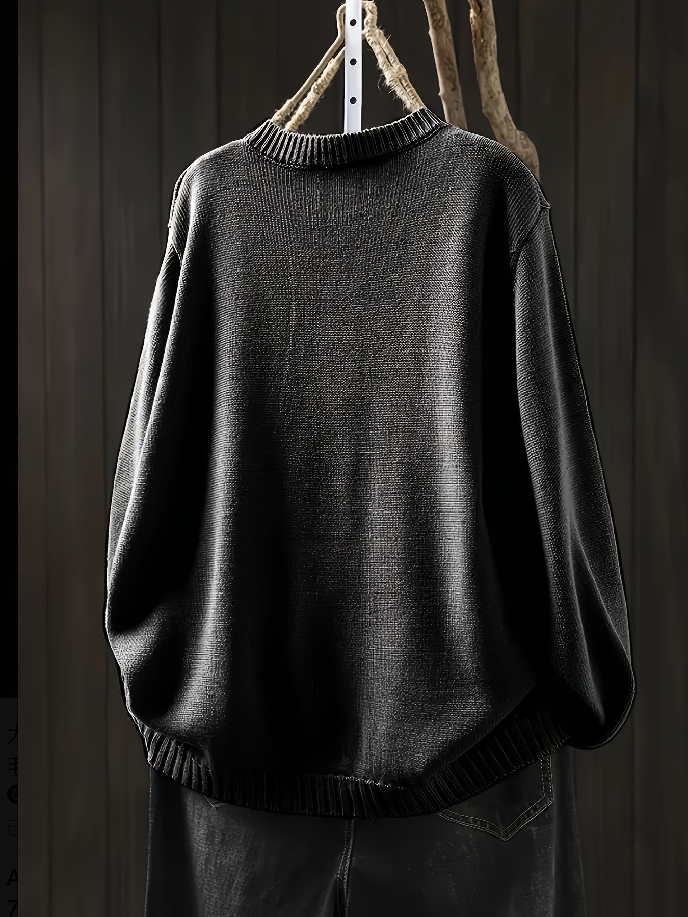Black cardigan sweater with ribbed crew neckline, cuffs, and hem