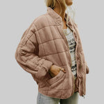 Tan quilted oversize step jacket with zip front, stand collar, and side pockets