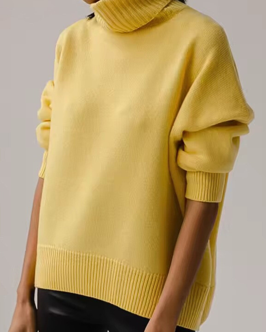 Oversized yellow turtleneck knit sweater with ribbed knit hem