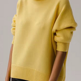 Oversized yellow turtleneck knit sweater with ribbed knit hem