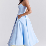 Light blue fitted corset dress with spaghetti straps and gathered flared midi skirt