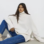 White oversized turtleneck sweater with long sleeves and ribbed hem