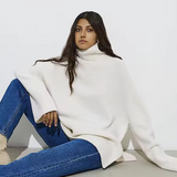 White oversized turtleneck sweater with long sleeves and ribbed hem