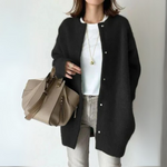 Black open-front cardigan with long sleeves and snap-button placket